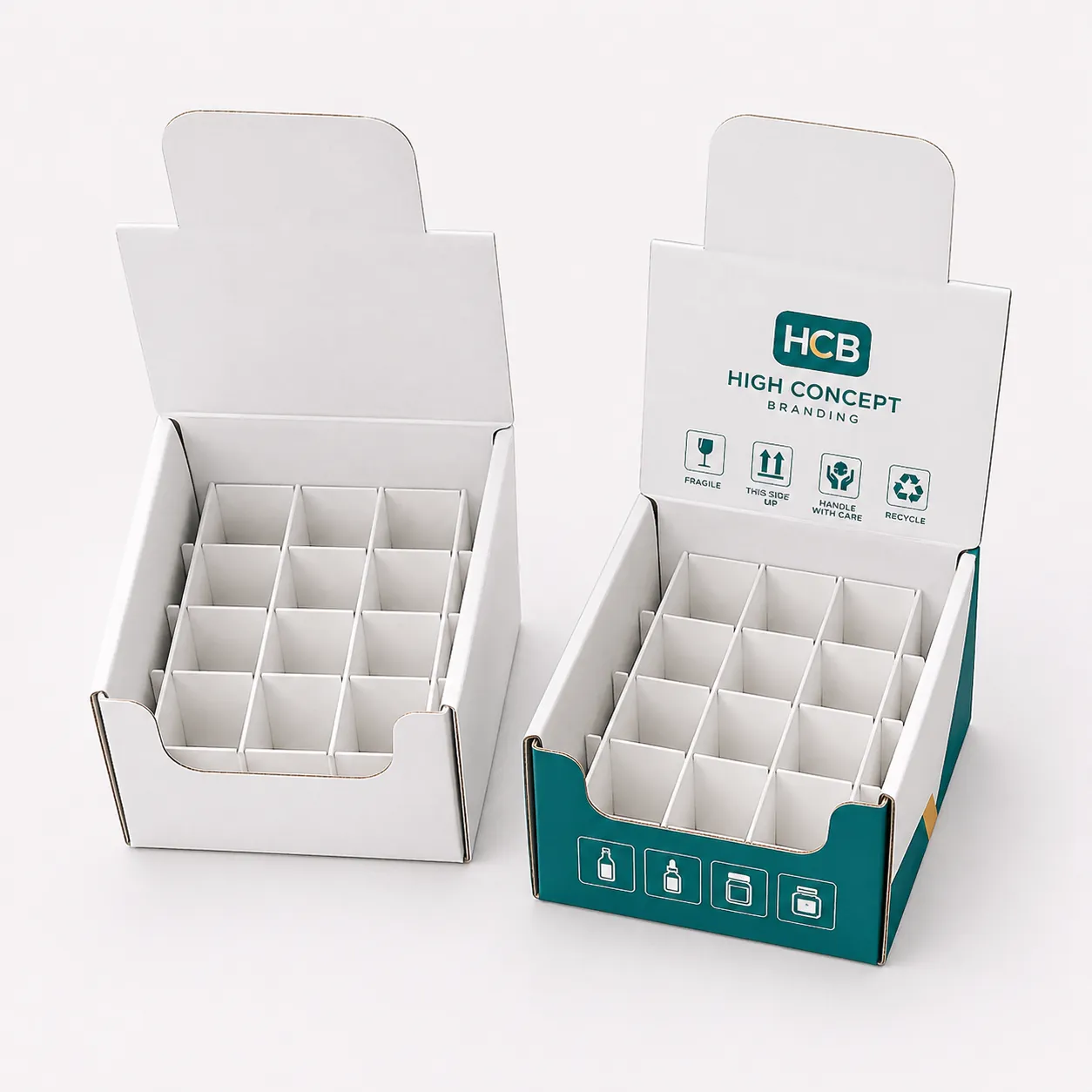 Two white counter display boxes with internal dividers and one featuring custom teal branding and logos. class=